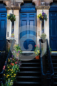 Blue Door, Colorful Stained Glass and Vibrant Flowers At the Entrance to A Victorian Tenement in Glasgow