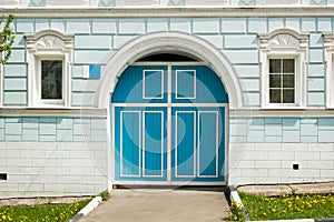 Blue Door Entrance In Stone Wall Of Residential Building.