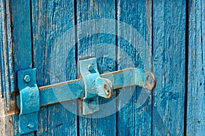 Blue Door of old boards with a latch