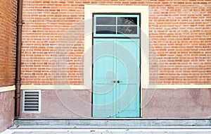 Blue door at orange brick wall,exterior building