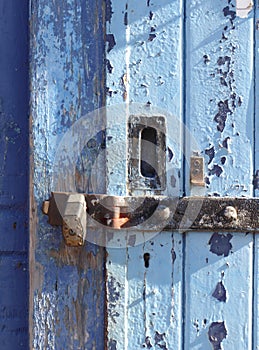 Blue door, paint peeling, locked