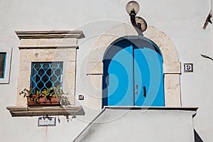 Blue Door And Window On The White Wall