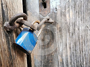 Blue Doorlock on old wooden door photo