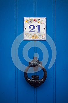 Blue doors with 21 digit and knocker