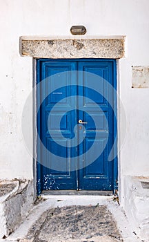 Blue double painted door in Greece.