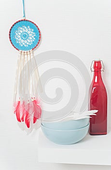 Blue dream catcher with red feathers