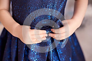 Blue dress. Great bow. Childrens hands. Horizontally