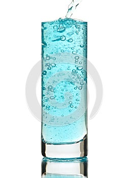 Blue drink being poured into a glass photo