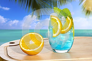 Blue drink with orange on a wooden board cocktail blue lagoon photo