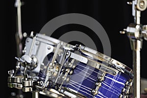 a blue drum set in a dark room with selective focus