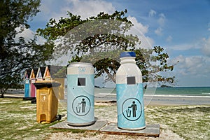 Blue dustbin by the beach