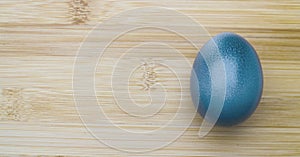 Blue easter egg on wooden background