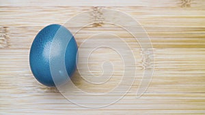 Blue easter egg on wooden background