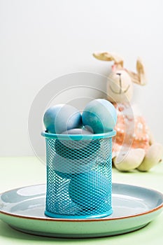 Blue easter eggs on pastel green background