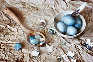 Blue easter eggs in a white plate. Rustic style.