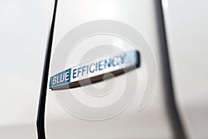 Blue efficiency icon on white car body