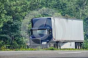 Blue Eighteen-Wheeler About to Merge Onto Highway