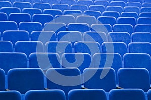 Blue empty seats in the hall are prepared for participants of mass events. Organization and holding of mass events, conferences or