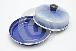Blue enamelled metal dish for butter on white background