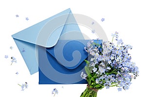 Blue envelope with wedding invitation card or birthday letter decorated with bouquet of wild forget me not flowers on white.