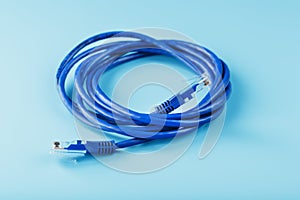 Blue Ethernet Cable Cord Patch cord on a blue background with free space