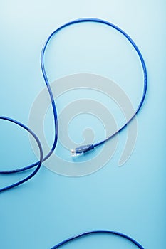 Blue Ethernet Cable Cord Patch cord on a blue background with free space