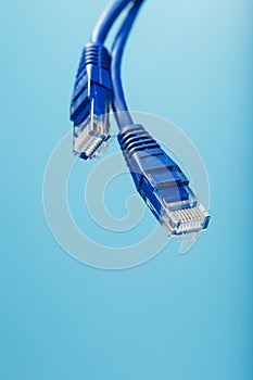 Blue Ethernet Cable Cord Patch cord on a blue background with free space