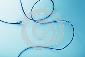 Blue Ethernet Cable Cord Patch cord on a blue background with free space