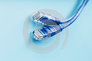 Blue Ethernet Cable Cord Patch cord on a blue background with free space