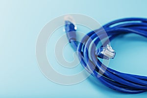 Blue Ethernet Cable Cord Patch cord on a blue background with free space