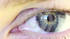 Blue Eye of a Beautiful Young Woman Looking Window.