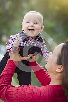 Blue-eyed Baby Boy Laughing With Mommy Outdoors