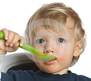 Blue eyed baby boy trying eat