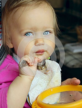 Blue Eyed Baby Girl eating.
