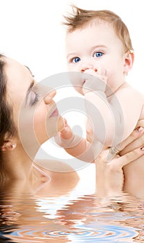 Blue-eyed baby in mother hands