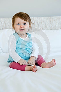 Blue eyed baby smiling at the camera