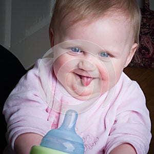 Blue-eyed Baby sucking bottle