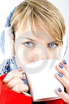 Blue-eyed girl drinks a coffee