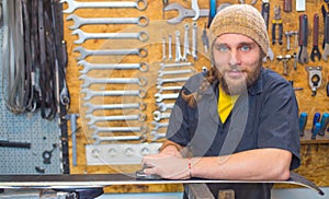 Blue eyed guy repairing ski in the workshop