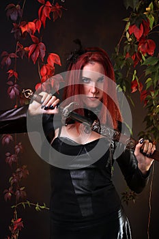 Blue Eyed Red Head Gothic Girl holding a fantasy sword among autumn vines