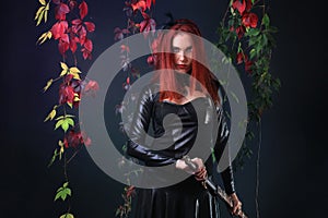 Blue Eyed Red Head Gothic Girl Pulling out a fantasy sword among autumn vines