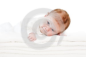 Blue eyes baby boy on white towels