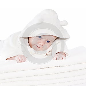 Blue eyes baby boy on white towels