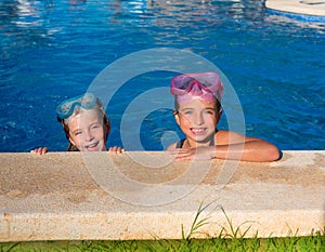 Blue eyes children girls on on blue pool poolside smiling