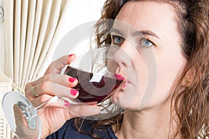 Blue eyes woman drinking a glass of wine