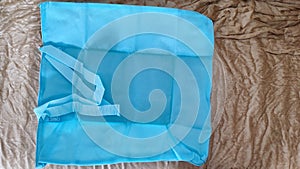 blue fabric bag lies on a gold blanket, objects background