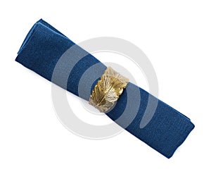 Blue fabric napkin with decorative ring for table setting on white background, top view