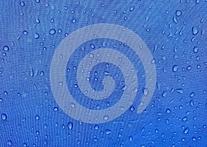 Blue fabric texture with water drops. Waterproof fabric
