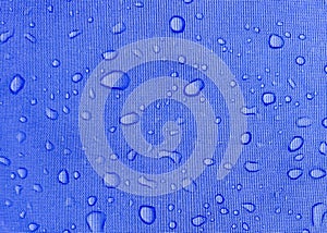 Blue fabric texture with water drops. Waterproof fabric