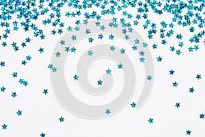 Blue falling stars glitter confetti on white festive background Sparkling Frame